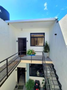a white house with stairs and plants on it at Estación 1501 - Casco histórico I in Juticalpa