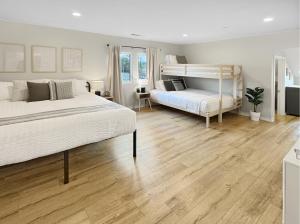 a bedroom with two beds and wooden floors at F-60 Disney Dream Craftsman in Anaheim +72 photos