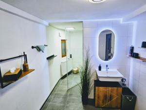 a bathroom with a sink and a mirror at INsight - workcation oldtown in Ingolstadt