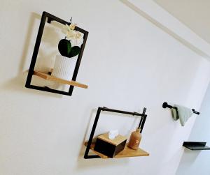 a shelf with a mirror and a box on a wall at INsight - workcation oldtown in Ingolstadt +24 photos