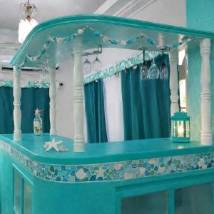 a table in a room with blue curtains and a starfish at Crieta Costello Homestay in San Juan