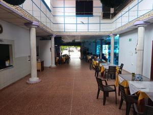 a dining room with tables and chairs in a building at Hotel Gallineral in San Martín