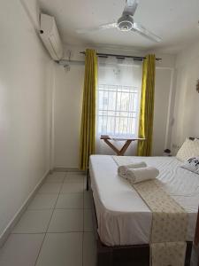 a bedroom with two beds and a window at Cindy's Ample home in Mombasa +23 photos