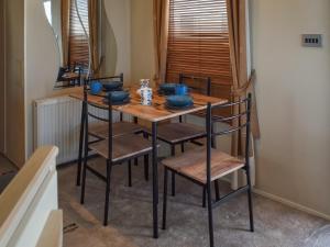 a dining room table with chairs and blue dishes on it at Sea View in Trimingham