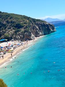a group of people on a beach in the water at Apartment Cela Vlore in Vlorë