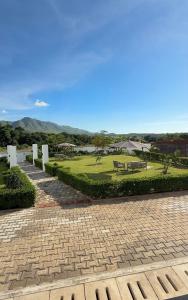 a park with a bench and a grass field at Tranquil Ridge BnB in Blantyre