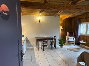 a dining room with a table and chairs in a room at Gîtes Ruraux à La Ferme D'Antan in Crolles
