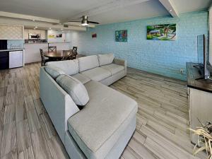a living room with a couch and a table at Sandy Shores in Port Aransas