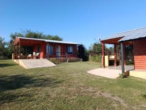 a house with a large yard in front of it at Cabañas a 5 minutos del río in Alta Gracia