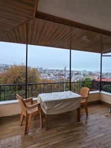 a bedroom with a bed and chairs on a balcony at Eşsız Manzara in Atakum