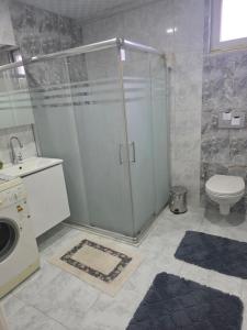 a bathroom with a shower and a toilet and a sink at Eşsız Manzara in Atakum