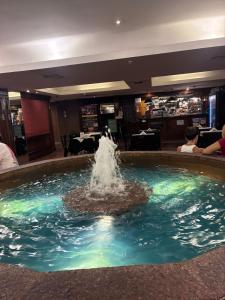 a water fountain in the middle of a restaurant at APART CyJ OBELISCO in Buenos Aires