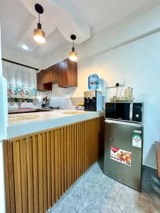 a kitchen with a refrigerator and a microwave at Hideout in Kisumu