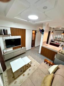 a living room with a couch and a television at Hideout in Kisumu
