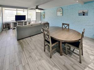 a living room with a table and a couch at Sandy Shores in Port Aransas