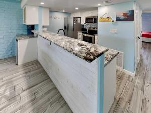 a kitchen with a counter top in a room at Sandy Shores in Port Aransas +18 photos