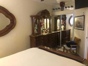 a bedroom with a dresser and a mirror and a bed at The Cozy Coast Nest in Oceano