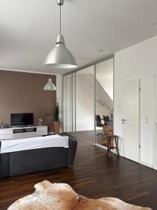 a bedroom with a bed and a living room at Six! Eat Work Sleep in Brühl