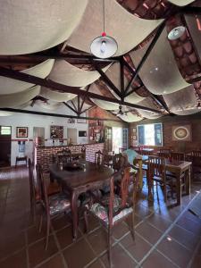 a dining room with a wooden table and chairs at Pousada das Estrelas in Areal