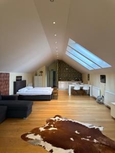 a large living room with a bed and a couch at Six! Eat Work Sleep in Brühl