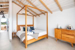 a bedroom with a canopy bed and a wooden dresser at Quinta do Ourives in Carvoeiro +55 photos