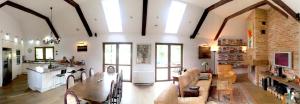 a large room with a kitchen and a living room at Dom w Przepitkach in Przepitki