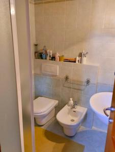 a bathroom with a toilet and a sink at Appartamento bambi abetone in Abetone +3 photos