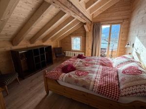 a bedroom with a bed in a room with wooden ceilings at Staubbachbänkli in Wengen