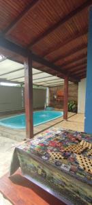 a swimming pool with a bed in front of it at Excelente rancho para descansar e pescar em carlopolis in Carlópolis