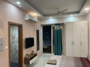 a bedroom with a bed and a tv at StayVerse74 in Noida