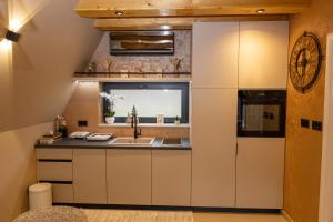 a kitchen with a sink and a refrigerator at "Vista Frame" JAZ - lake view in Višegrad