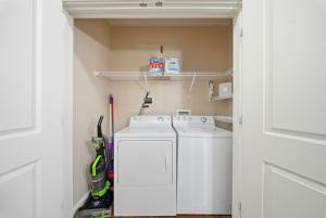 a laundry room with a washer and dryer at Stylish 2BR w Balcony, Pool & Pet-Friendly #15 in Tampa