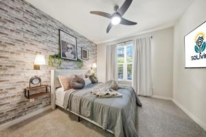 a bedroom with a brick wall and a bed at Stylish 2BR w Balcony, Pool & Pet-Friendly #15 in Tampa +30 photos