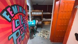 a room with a skateboard on the wall and a bedroom at COACHHOSTEL7 in São Paulo