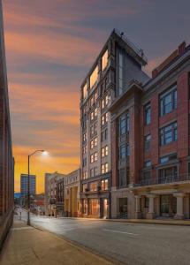 a building on a street with a sunset in the background at Park Hotel Studio Suite 203 in Chattanooga