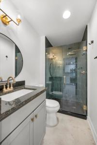 a bathroom with a shower and a toilet and a sink at Park Hotel Studio Suite 203 in Chattanooga