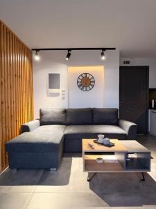 a living room with a couch and a coffee table at Kiriakos Apartment in Kalamata +28 photos