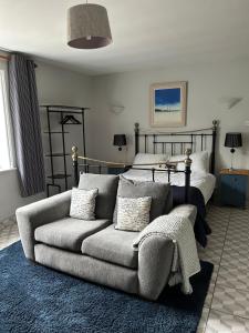 a living room with a couch and a bed at Caistor Bed & Breakfast in Caistor