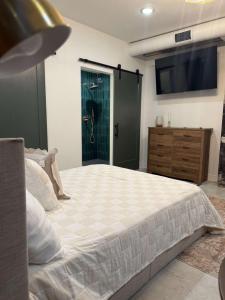 a bedroom with a large bed and a tv on the wall at Park Hotel Studio Suite 207 in Chattanooga