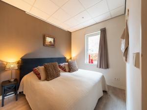 a bedroom with a white bed and a window at Apartment in Bergen near Sandy Beaches in Bergen