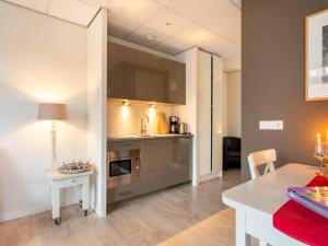a kitchen and dining room with a table and a counter at Apartment in Bergen near Sandy Beaches in Bergen