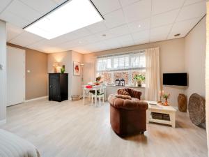 a living room with a couch and a table at Apartment in Bergen near Schoorl Dunes in Bergen