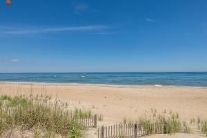 a sandy beach with the ocean in the background at Mitch's Haven - Kitty Hawk MP 2, Oceanfront, 3 Bedrooms, Vintage Charming Cottage in Kitty Hawk