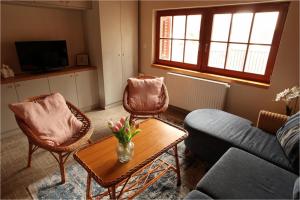 a living room with a couch and chairs and a table at Colorful Life by STN in Balatonudvari