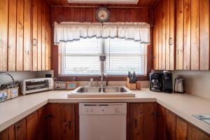 a kitchen with a sink and a window at Mitch's Haven - Kitty Hawk MP 2, Oceanfront, 3 Bedrooms, Vintage Charming Cottage in Kitty Hawk
