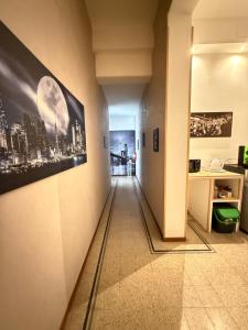 a hallway leading to a room with a picture on the wall at GUEST HOUSE BOSCO in Palermo