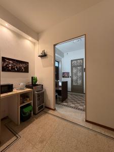 a room with a door open to a room with a desk at GUEST HOUSE BOSCO in Palermo