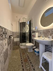 a bathroom with a shower and a toilet and a sink at GUEST HOUSE BOSCO in Palermo +29 photos