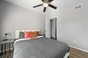 a bedroom with a bed with a ceiling fan at 2-bedroom with large living area in Denton +12 photos
