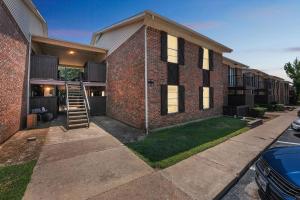 a brick house with a staircase on the side of it at 2-bedroom with large living area in Denton